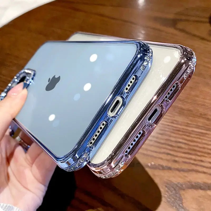 a person holding an iphone with a clear case