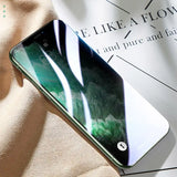 a green iphone on a white surface