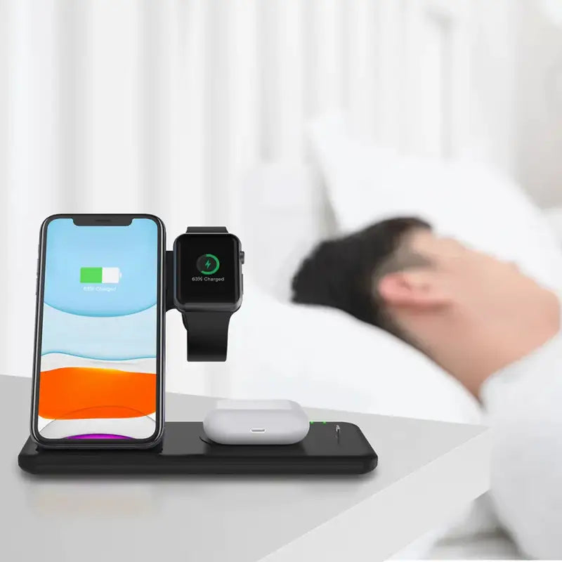 an iphone and a wireless charging station on a bed