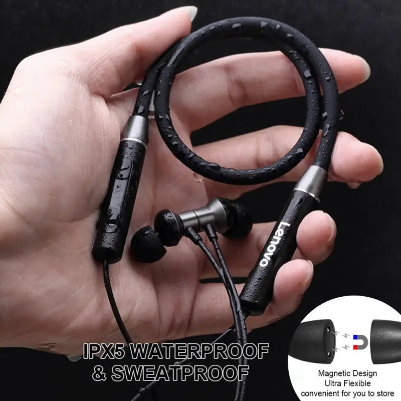 a hand holding a pair of earphones