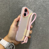 Iridescent phone case with pink wrist strap.