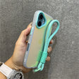 Iridescent phone case with turquoise wrist strap.