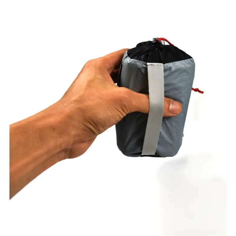 a hand holding a small bag with a zipper