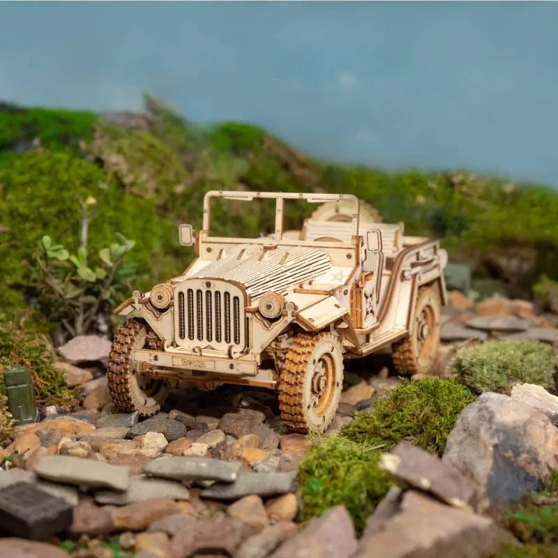 a toy jeep is sitting on some rocks