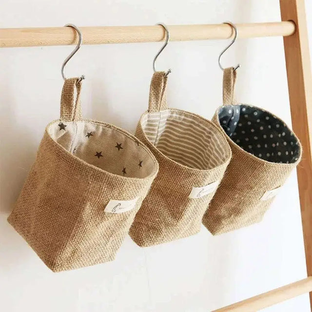 three small baskets hanging on a wooden ladder