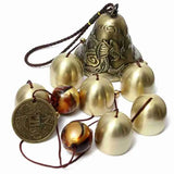 a brass bell with bells and a coin