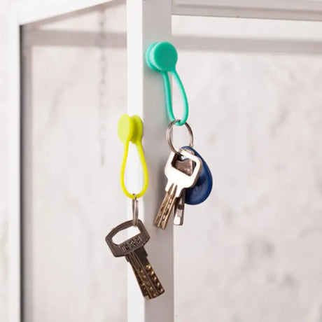 a key holder with two keys hanging on it