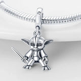 a silver plated charm with a small yodah holding a sword