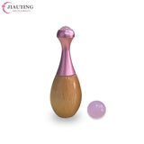 a pink and brown wooden egg with a pink egg inside