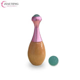 a wooden bowling ball with a pink and green ball