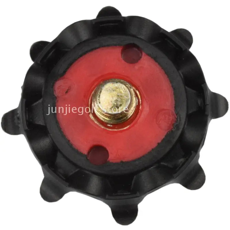 a red and black plastic spe with a brass button