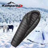 a sleeping bag in the snow with horses in the background