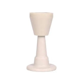 a white candle holder with a white base