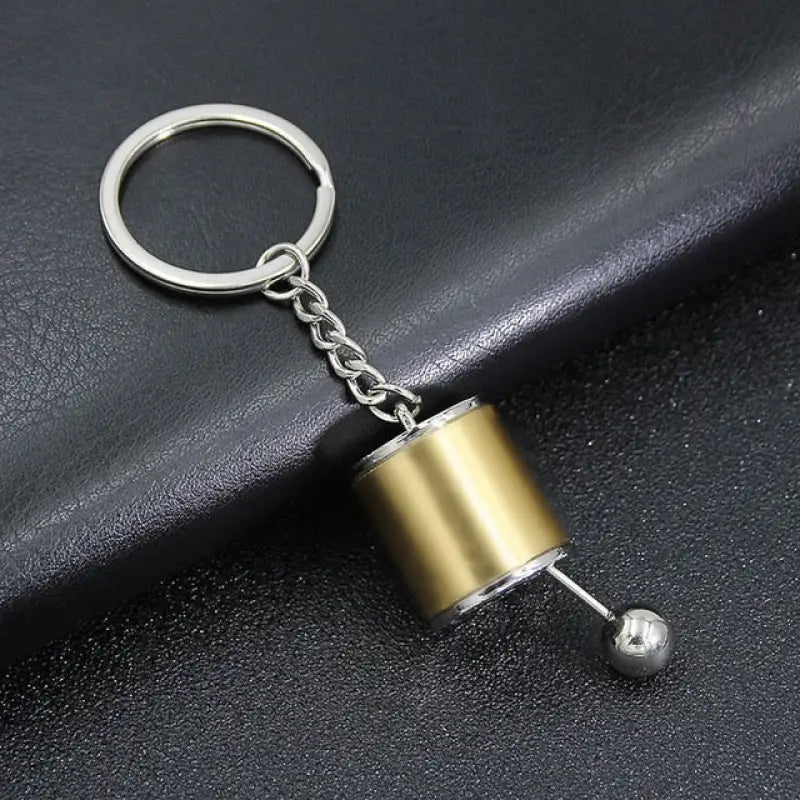 a metal pipe keychai with a metal pipe on it