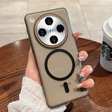 Khaki phone case with a circular camera cutout, an ’H’ in the center, a magnetic ring, and a kickstand.