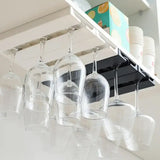 a kitchen light fixture with wine glasses hanging from the ceiling