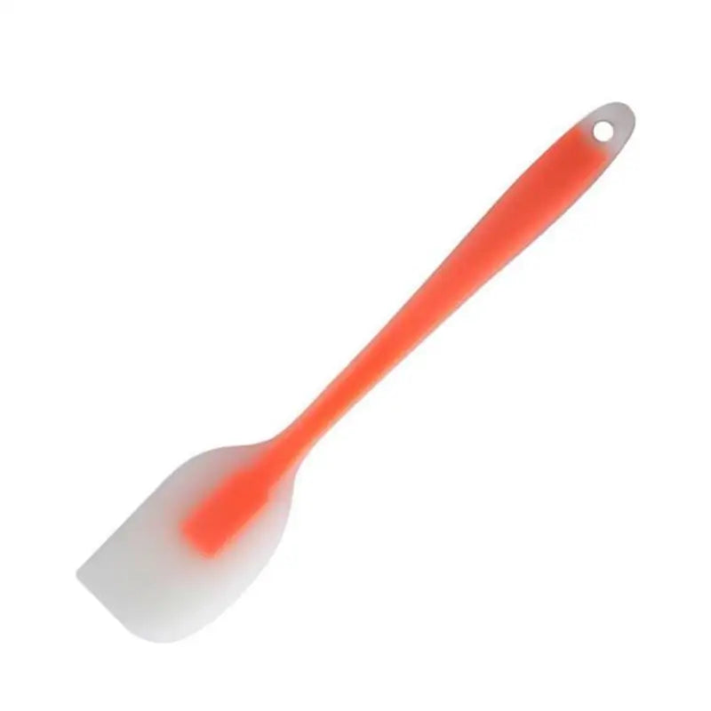 a plastic spat with a red handle