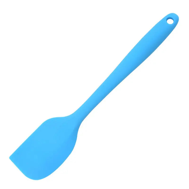 a close up of a blue spatula on a white background