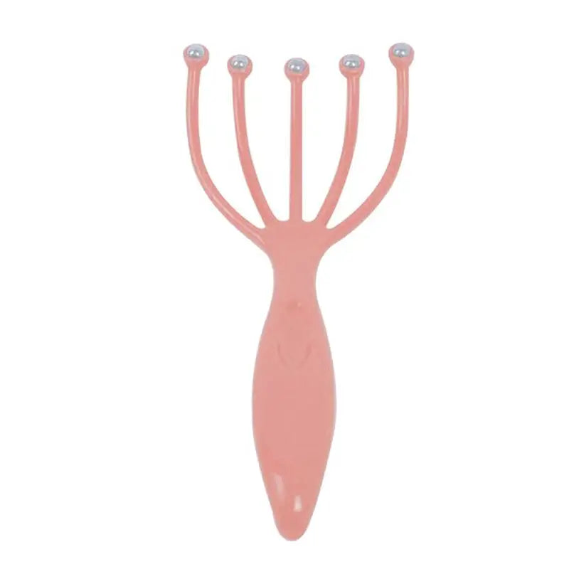 a pink plastic hair clip with two metal balls on it