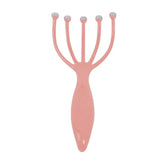 a pink plastic hair clip with two metal balls on it