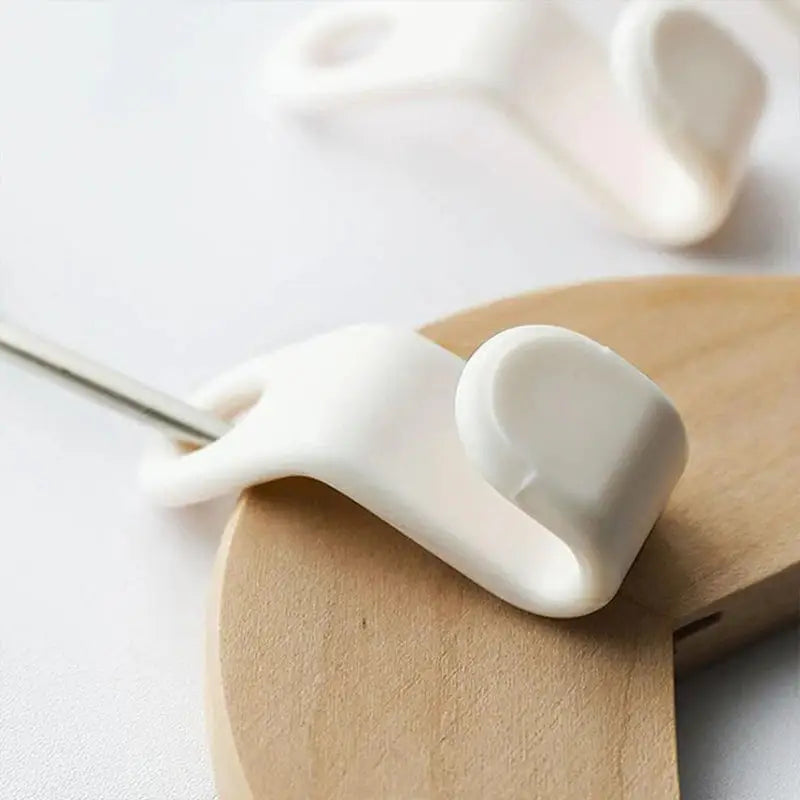 a wooden spoon with a white heart on it