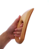 a hand holding a wooden spoon