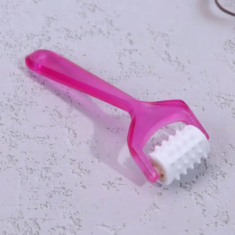a toothbrush with a pink handle and white bre