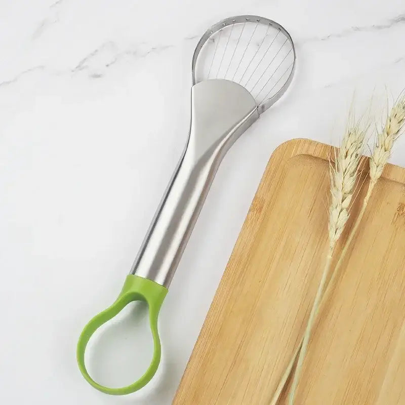 a knife and a cutting board with a green handle