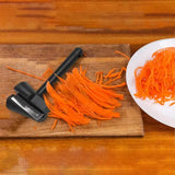 a knife and carrots on a cutting board