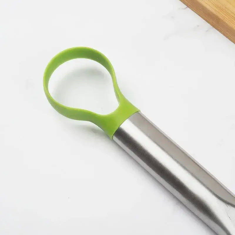 a knife with a green handle on a white surface