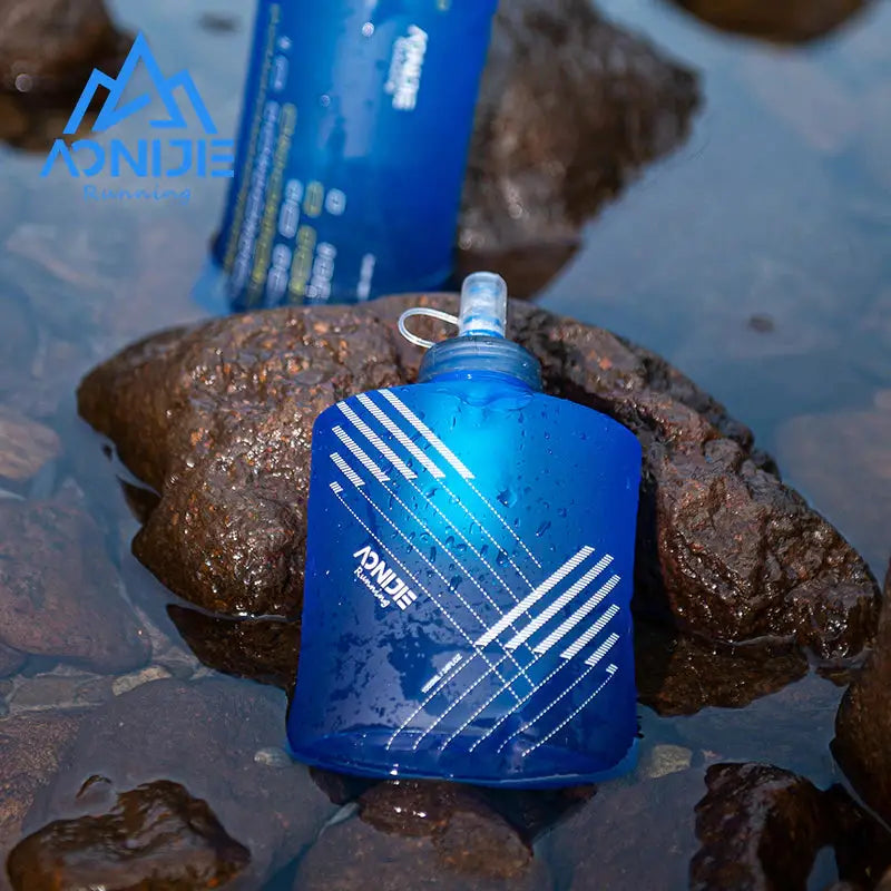 a blue water bottle sitting on top of rocks