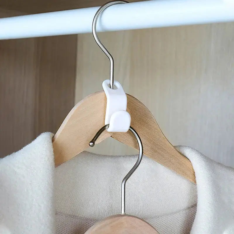 a wooden hanger on a white coat rack