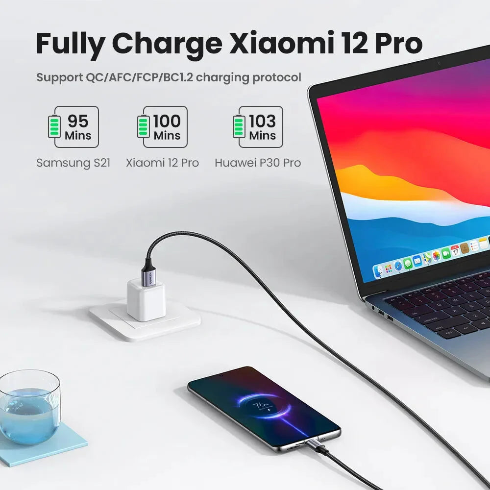 There is a laptop and a cell phone on a table
