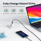 There is a laptop and a cell phone on a table