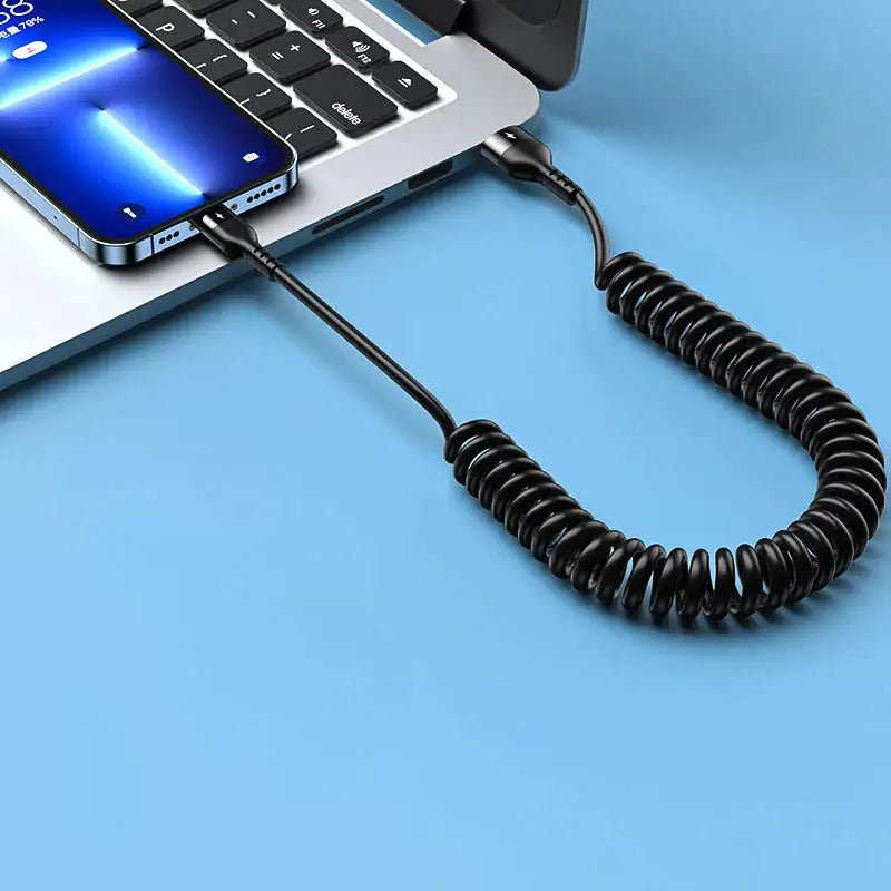 a laptop with a coiled cord attached to it