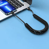 a laptop with a coiled cord attached to it