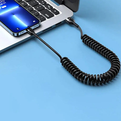 A laptop with a coiled cord attached to it