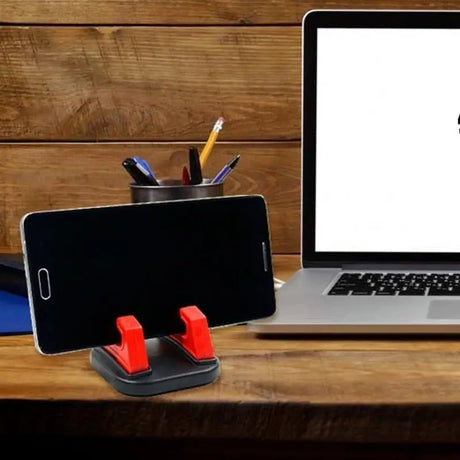 a laptop and a phone on a desk