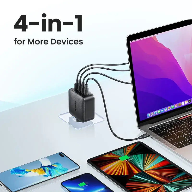 A laptop, phone and other devices on a table