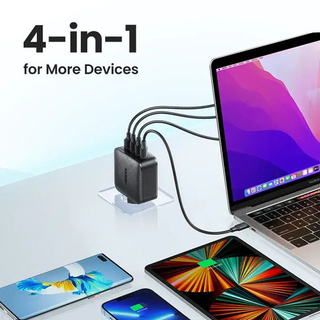 A laptop, phone and other devices on a table
