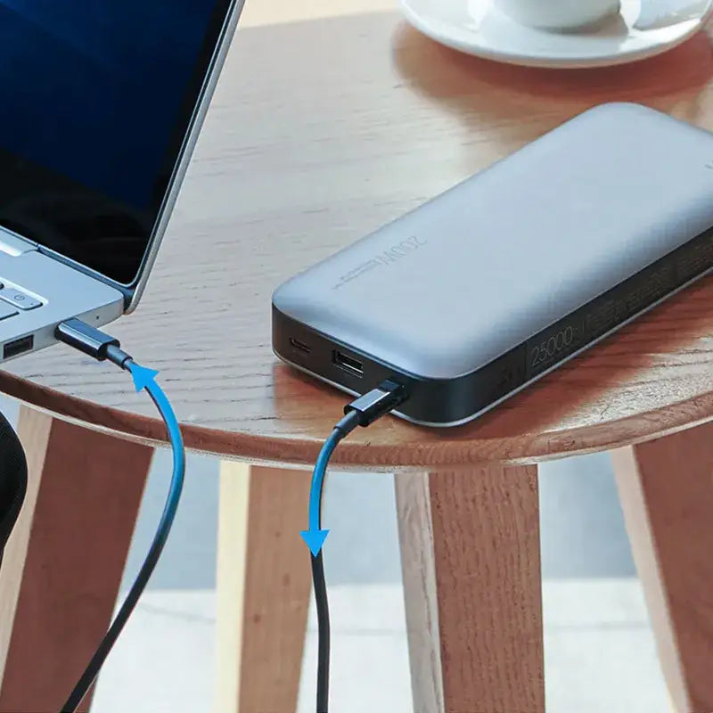 a laptop and a power bank on a table