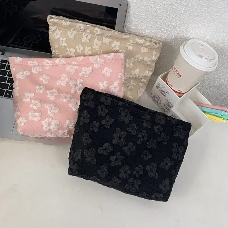 a laptop and a small bag on a desk