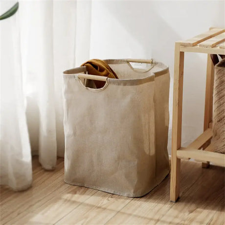 a white laundry bag next to a wooden chair