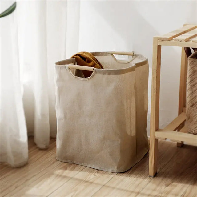a white laundry bag next to a wooden chair