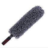 a close up of a duster with a black handle