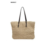 a large straw bag with a black handle