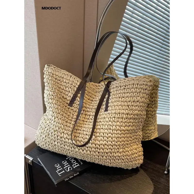 a large woven bag with a brown handle