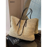 a large woven bag with a brown handle