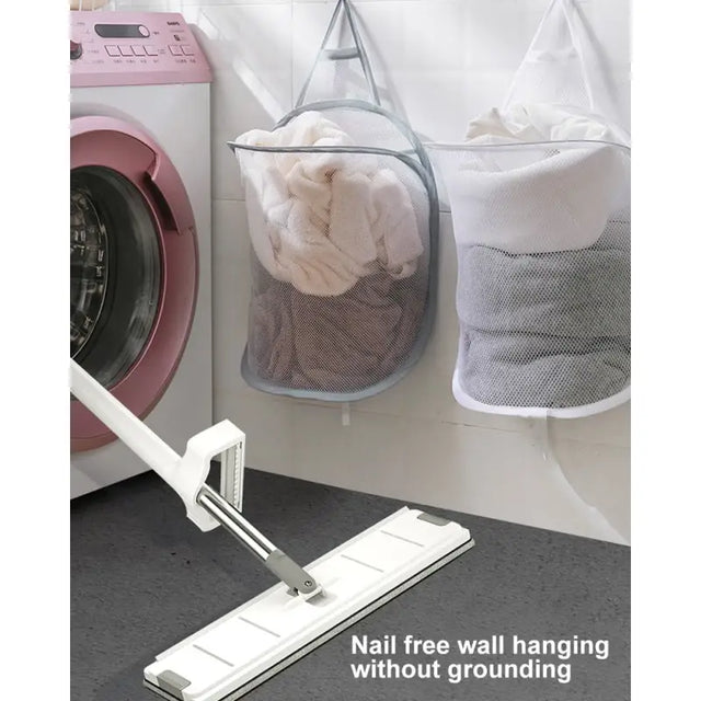 a laundry bag hanging on the wall next to a washing machine