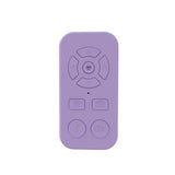 Lavender-colored remote control with circular and rectangular buttons.